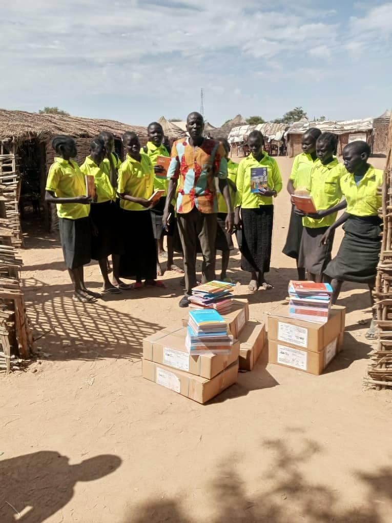 Volunteers distributing books and learning materials